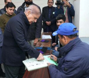 PML-N President Shehbaz Sharif giving thumb impression on ballot paper in Model Town polling station during the General Election-2024