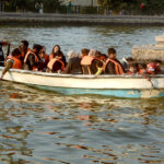 Families enjoy a boat ride in Greater Iqbal Park.