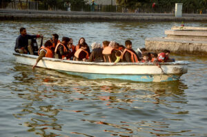 Families enjoy a boat ride in Greater Iqbal Park.