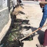 A worker busy in cleaning and pulling out garbadge from nullah near Kashrote area