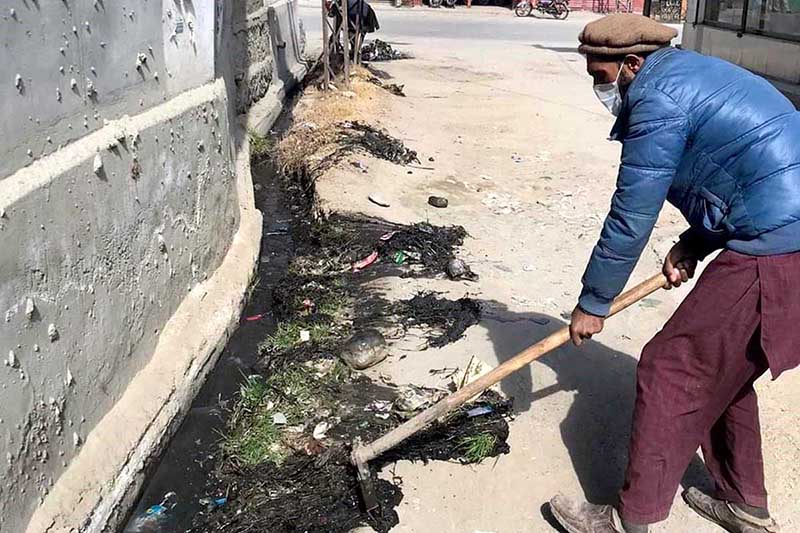 A worker busy in cleaning and pulling out garbadge from nullah near Kashrote area