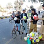 A vendor selling footballs to earn his livelihood.