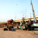 Heavy machinery being used to expand road during development work at Ravi bridge.
