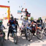 Bikers show the victory sign before starting the Race during 19th TDCP Cholistan Desert Rally 2024