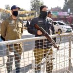 Police officials standing alert outside the polling station during General Election-2024