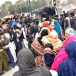 Volunteers distributing food among people at Gulberg Area