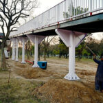 Worker busy paint on the pedestrian bridge at Srinagar Highway in the Federal Capital.
