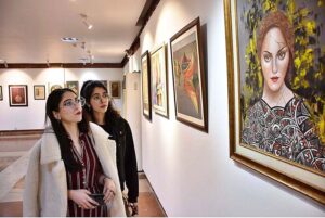 Visitors viewing the displayed stuff during Painting, Sculpture, Ceramic and Calligraphy Exhibition organized by Arts and Craft Forum at PILAC Gaddafi Stadium