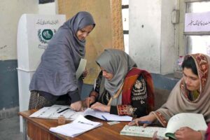 A female voter casting her vote in Queen Mary College Polling Station during General Election-2024