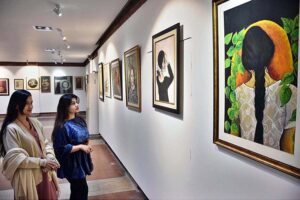 Visitors viewing the displayed stuff during Painting, Sculpture, Ceramic and Calligraphy Exhibition organized by Arts and Craft Forum at PILAC Gaddafi Stadium