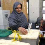 A female voter casting her vote in Queen Mary College Polling Station during General Election-2024