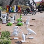 A vendor displaying colorful plant pots to attract customers at roadside in the Federal Capital.