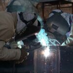 Workers welding pipes of gas line at Aabpara area in the federal capital.