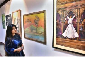 Visitors viewing the displayed stuff during Painting, Sculpture, Ceramic and Calligraphy Exhibition organized by Arts and Craft Forum at PILAC Gaddafi Stadium