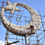 A worker busy final touch of making the sculpture of Moon and star of Pakistani Flag at Istanbul Square
