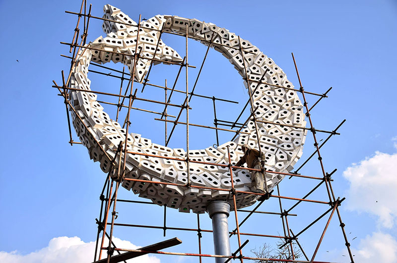 A worker busy final touch of making the sculpture of Moon and star of Pakistani Flag at Istanbul Square