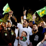 Supporters of Former Prime Minister Nawaz Sharif's party 'Pakistan Muslim League-N' dance to celebrate their party victory at Model Town