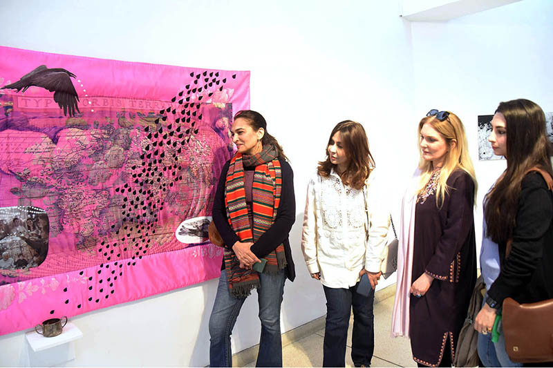 Women viewing artwork during the Lahore Literary Festival at Al-Hamra