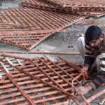 Worker busy in preparing bamboo fence at his workplace