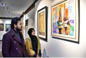Visitors viewing the displayed stuff during Painting, Sculpture, Ceramic and Calligraphy Exhibition organized by Arts and Craft Forum at PILAC Gaddafi Stadium