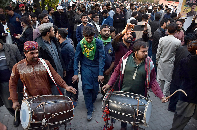 Supporters of Former Prime Minister Nawaz Sharif's party 'Pakistan Muslim League-N' dance to celebrate their party victory at Model Town