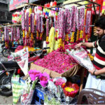 A vendor displaying flower bouquets to attract customers at his workplace