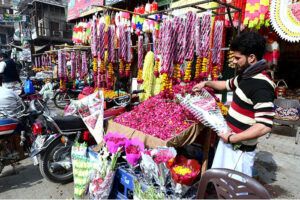  A vendor displaying flower bouquets to attract customers at his workplace