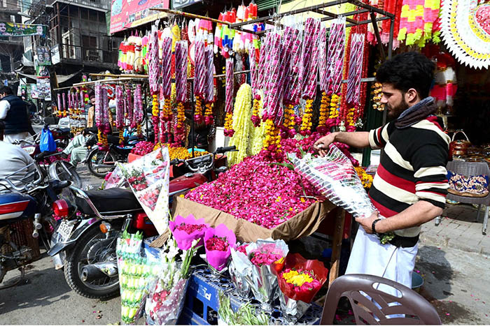 A vendor displaying flower bouquets to attract customers at his workplace