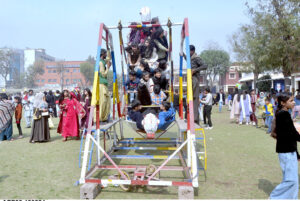 Students enjoying swing during funfair at La Salle Higher Secondary School