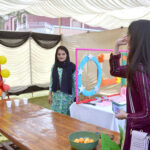 Students enjoying swing during funfair at La Salle Higher Secondary School