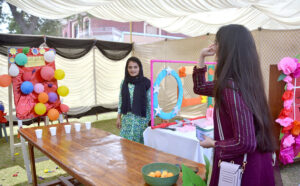 Students enjoying swing during funfair at La Salle Higher Secondary School
