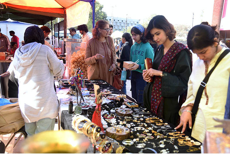 Women viewing artwork during the Lahore Literary Festival at Al-Hamra