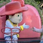 A girl shakes hand with a statue installed at Lake View Park in the federal capital.