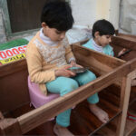 Children enjoy playing game on mobile phone