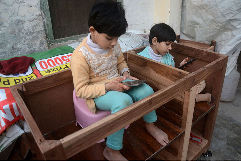 Children enjoy playing game on mobile phone