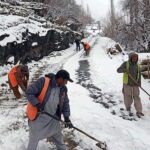 Workers busy removing snow on road to help smooth flow of vehicles at Olding area