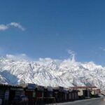 An attractive view of thick clouds hovering over the snow covered mountain