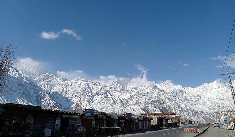 An attractive view of thick clouds hovering over the snow covered mountain