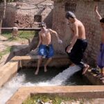 Youngster enjoying bathing on running tube-well at Hala Naka Area