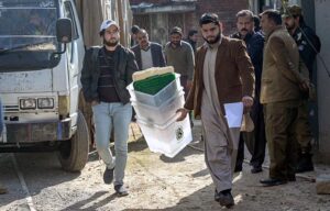 Polling staff on the way after receiving polling material at distribution Centre for General Elections 2024.