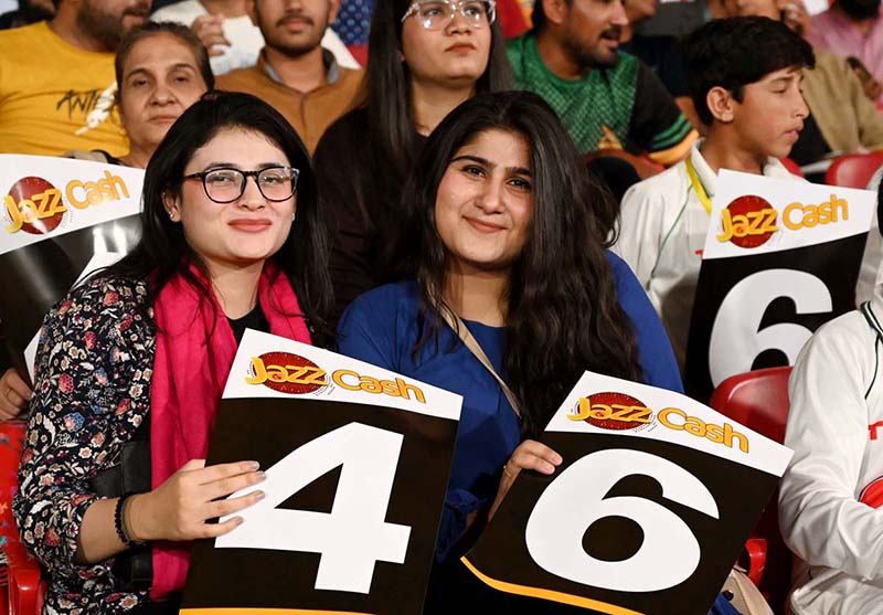 Spectators enjoy during the Pakistan Super League (PSL 9) Twenty20 cricket match between Karachi Kings and Islamabad United at the National Cricket Stadium