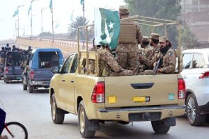 Security officials holding flag march in the city to develop a sense of protection among the masses and maintain law and order situation during the General Election 2024