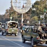 A convoy of army personnel patrols along a road in the city to develop a sense of protection among the masses and maintain law and order situation during the General Election 2024