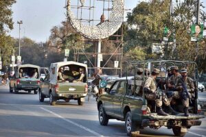 A convoy of army personnel patrols along a road in the city to develop a sense of protection among the masses and maintain law and order situation during the General Election 2024