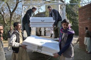 Polling staff on the way after receiving polling material at distribution Centre for General Elections 2024.