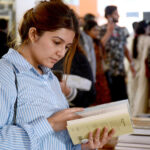 A lady taking keen interest in books at a stall at 15th Karachi Literature Festival (KLF)