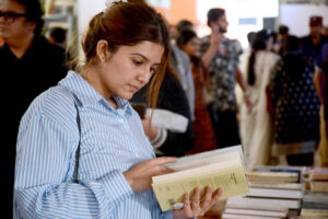A lady taking keen interest in books at a stall at 15th Karachi Literature Festival (KLF)