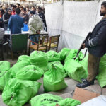 Security personnel on duty during distribution of election materials, at Anar Kali Revenue Board office for upcoming General Election February 08, 2024