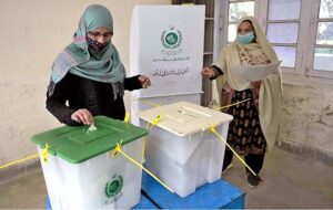 Women showing their identity card while standing in queue to cast their vote in polling station during General Election-2024