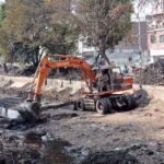 Irrigation department worker cleaning aRakh Branch canal with the help of caterpillar during canal cleaning campaign